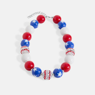 Necklace with red, white, and blue beads on a light gray background