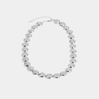 A collar-length necklace composed of a continuous strand of round, slightly irregular hammered-finish disc links connected by a lobster-claw clasp with an adjustable extender chain.