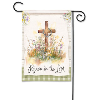Decorative garden flag with a cross, flowers, and 'Rejoice in the Lord' text on a white background.