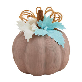 Decorative pumpkin with brown leaves and a white flower