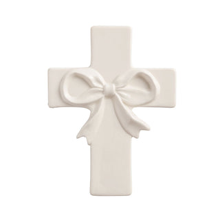 White cross-shaped decorative item with a bow 