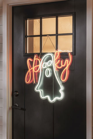 Neon sign of a ghost with 'Happy Halloween'.