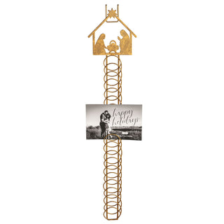 Decorative nativity scene stand with a 'Happy Holidays' card 