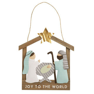 A gold-colored star gleams above the holy family, and the base is inscribed with the classic phrase, "JOY TO THE WORLD." The mix of materials, including wood and a corrugated metal-like texture, gives it a cozy, handcrafted feel. Hung by a simple twine cord, this nativity hanger is a heartfelt and elegant addition to any door, wall, or entryway.