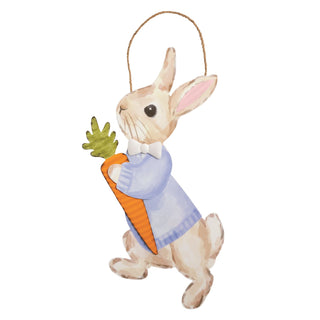 Decorative door hanger of a rabbit figurine holding a carrot on a white background