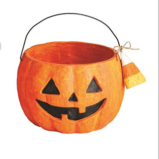 Pumpkin-shaped candy bucket with a face design 