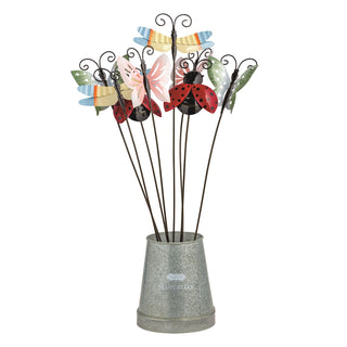 Decorative metal garden stakes shaped like butterflies, dragonflies, and ladybugs in a pot on a white background.