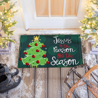 Christmas-themed doormat with a tree and text 'Jesus is the reason for the Season'