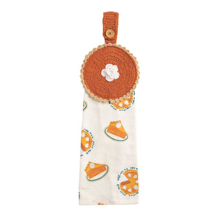 Crocheted orange pot holder with a white flower design and pumpkin pie slice pattern