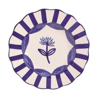 Decorative plate with bluestripes and floral design on a white background