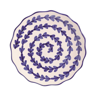 Decorative plate with blue leaf pattern on a white background