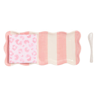 Pink and white striped hostess dish with leopard print pattern towel on a white background