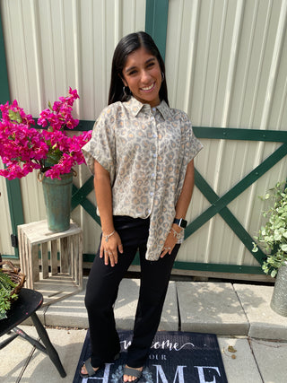 Fierce Meets Flowy – Taupe Leopard Button Down Plus

Unleash your wild side with this taupe leopard print top that effortlessly blends sass and sophistication. The relaxed fit and subtle sheen of the fabric elevate this classic animal print into something truly chic. With a button-down front, dolman-style short sleeves, and a flattering back yoke with gathered detail, this top is easy to wear and easy to love.

Pair it with your favorite denim for an everyday look or dress it up with black skinnies and bold