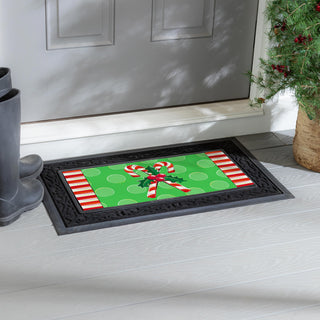 Christmas-themed doormat with candy canes on a green background.