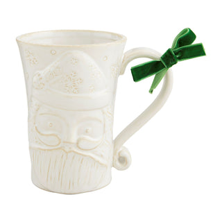 White mug Santa with decorative handle and green bow on a white background