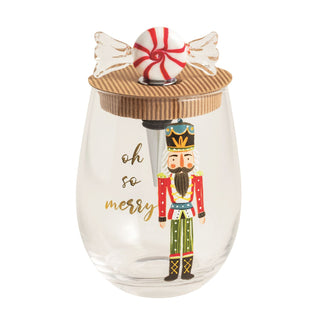 Clear glass tumbler with a nutcracker design and candy 