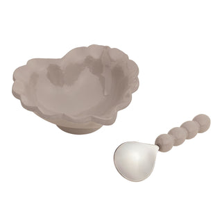 A grey heart shaped ceramic bowl with a decorative spoon 