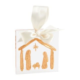 square ornament with a nativity scene design and a white bow