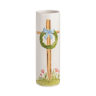 Decorative vase with a cross, wreath, and flowers on a white background