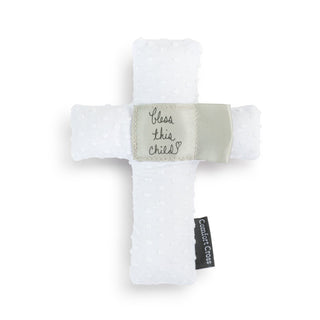 White cross-shaped item with 'Bless this child' tag on a white background