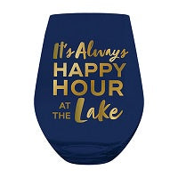 A navy blue stemless wine glass featuring the phrase 'It's Always HAPPY HOUR AT THE Lake' in gold lettering, shown against a plain white background.