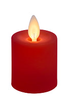 Red candle with a lit wick on a white background