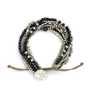 Multistrand beaded bracelet with a cross charm on a white background