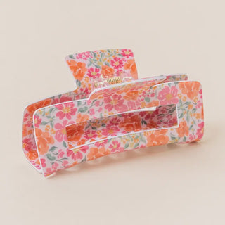 Floral-patterned hair clip on a beige background