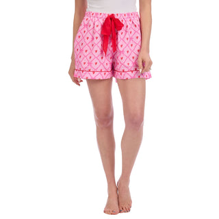 Pink patterned shorts with a red bow