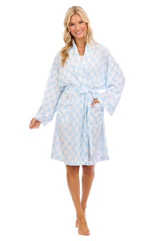 Woman wearing a light blue patterned robe on a white background