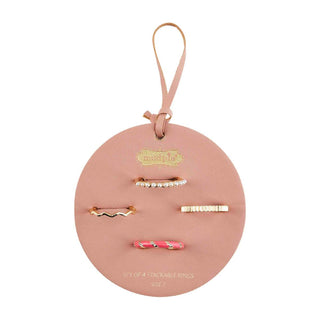 Set of four stackable rings on a pink round card with a handle
