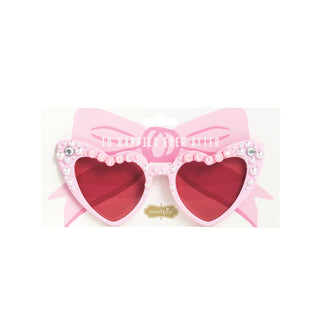 Heart-shaped sunglasses with a pink bow and red lenses on a white background