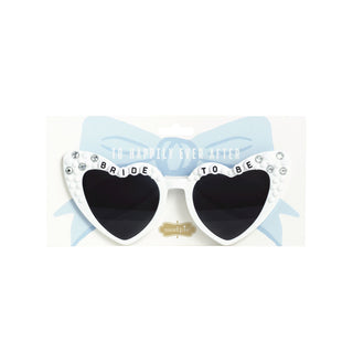 Heart-shaped sunglasses with 'Bride to Be' text and a bow on a white background
