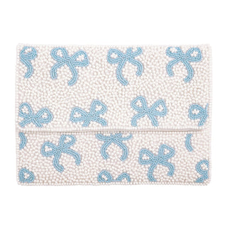 White clutch with blue bow patterns on a white background