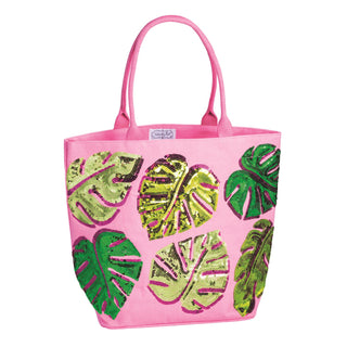 Pink tote bag with green leaf patterns on a white background