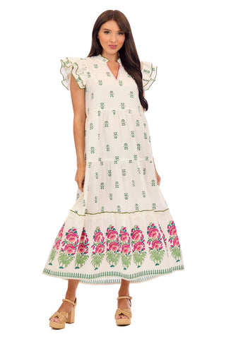 Woman wearing a white midi dress with floral patterns on a white background