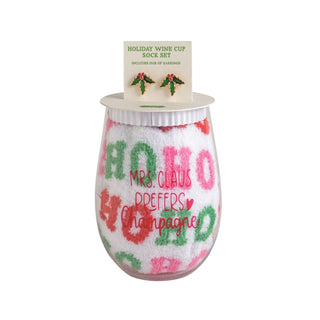 Stemless holiday wine glass paired with white fuzzy socks and mistletoe earrings