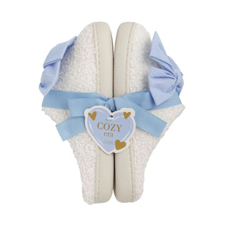 White slippers with blue bows and a 'Cozy Era' tag on a white background