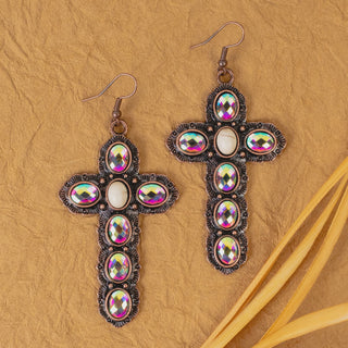 Antique bronze cross dangle earrings set with iridescent crystals and a central white stone.