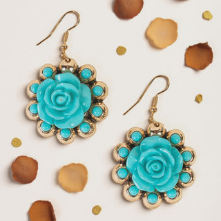 Gold dangle earrings featuring a turquoise rose center surrounded by a halo of matching small turquoise stones.