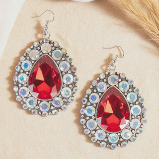Teardrop dangle earrings with a large red gem surrounded by iridescent crystal rhinestones.