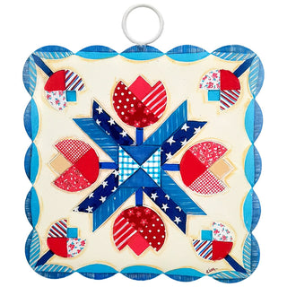 Decorative quilt with red, blue, and white patterns on a white background