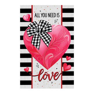 Card with a pink heart, checkered bow, and 'All You Need Is Love' text on a black and white striped background.