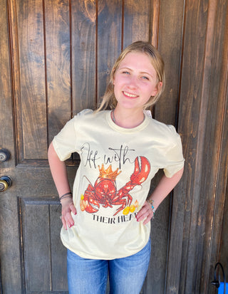 A Graphic tee shirt of a crawfish wearing a crown and Off with their heads written and corn on the cob also has bling