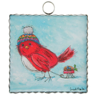 Charm with cartoon cardinal with colorful beanie carrying a wagon in the snow