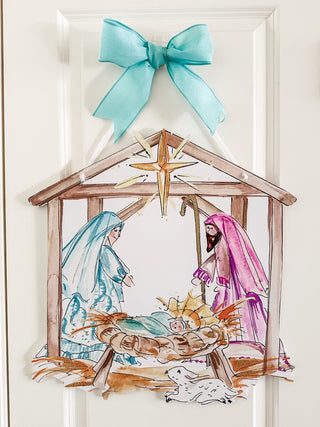 Decorative doorhanger of nativity scene with Mary, Joseph, and baby Jesus in a manger