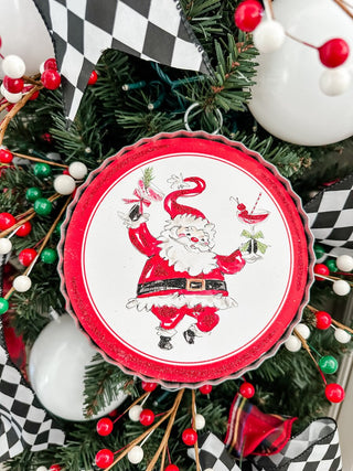 Cheerful Santa with cocktails in hand on a decorative charm