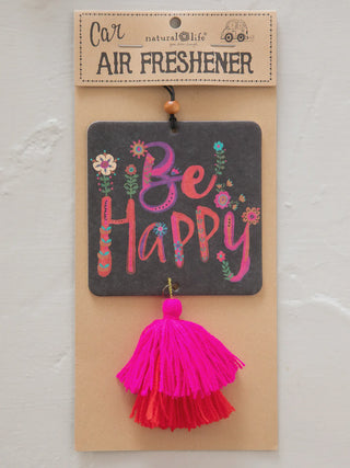 Air freshener with 'Be Happy' text and pink tassel on a beige card