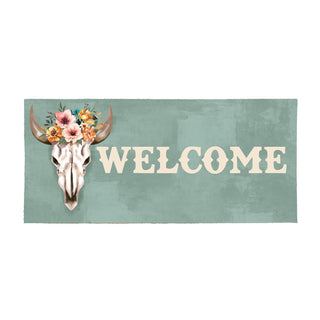 Decorative sign with cow skull, flowers, and 'WELCOME' text on a green background