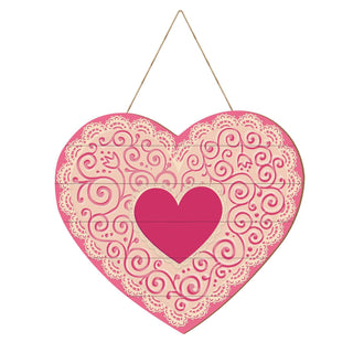 Heart-shaped decorative item with pink and beige lace pattern on a white background